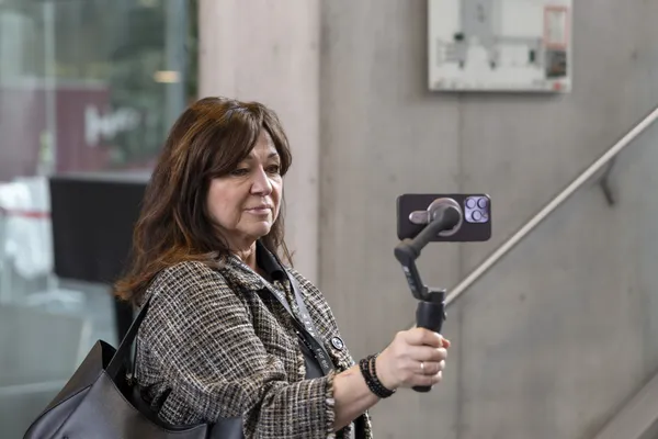 2026: Teilnehmerin filmt mit Smartphone an einem Gimbal im Foyer beim eDay Salzburg.