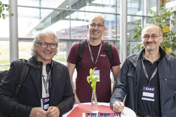 2026: Drei Personen mit Namensschildern stehen in der Lobby und lächeln beim eDay Salzburg.